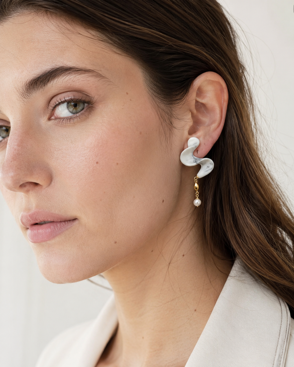 Profile view of ZELIN ART jewelry worn by model