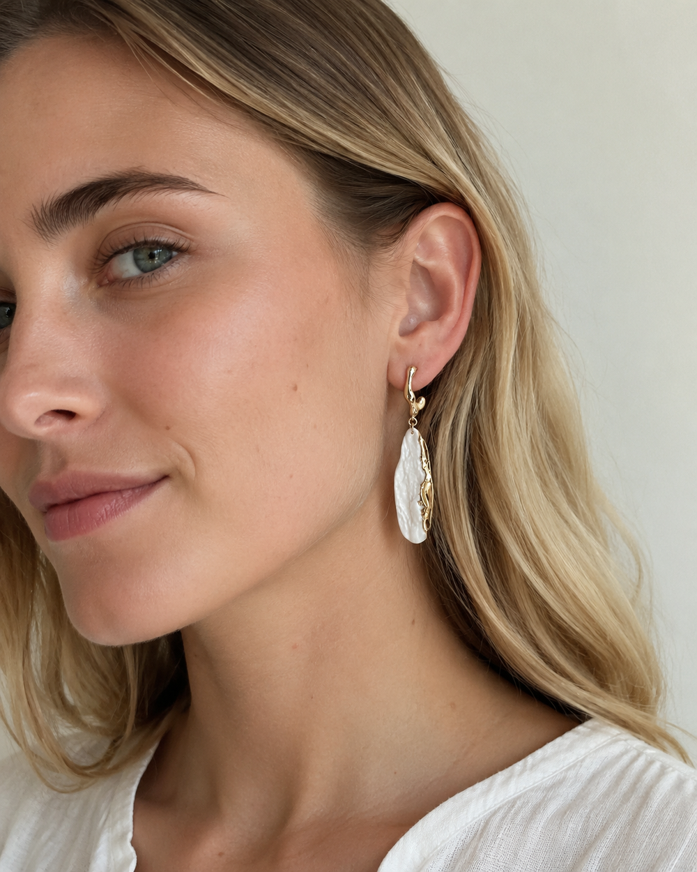 Close editorial crop of ZELIN ART earrings worn by model