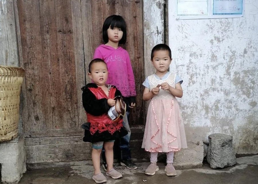 Children photographed during an education support visit in a mountain community